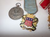 three medals and a medal sitting on a table