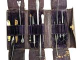 several pairs of scissors are in a case with a pair of scissors in it