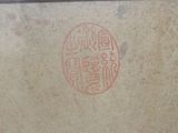a picture of a box with a stamp on it sitting on a table
