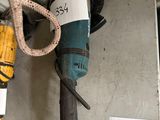 a picture of a drill on a shelf in a room