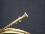 a brass instrument that is sitting on a black surface