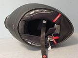 a helmet with a seat attached to it sitting on the floor