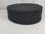 a stack of black sponges sitting on top of a white surface