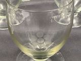 four glasses of water sitting on a table next to each other