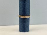 a blue cylinder with a gold band sitting on top of it