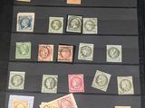 a lot of stamps in a black case on a table