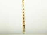 a close up of a gold bracelet on top of a white napkin