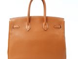 a brown leather handbag on a white background