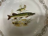 a plate with two fish on it on a table