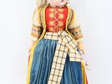 a doll of a woman wearing a dress and hat