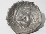 an image of a silver plate with a woman on it