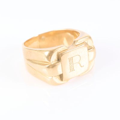 a picture of a gold ring with the letter r on it