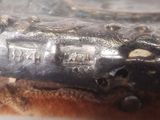 a close up of a silver object with writing on it