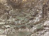 a silver plate with a painting of a man and a woman in the water