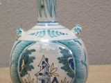 a blue and white vase sitting on a table