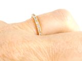 a woman ' s hand with a diamond ring on it