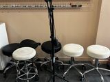four stools and a microphone stand in a room