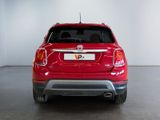 the back end of a red fiat suv parked in a garage