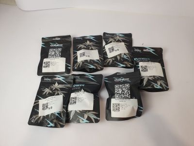 six packets of tea sit on a table with a white table cloth