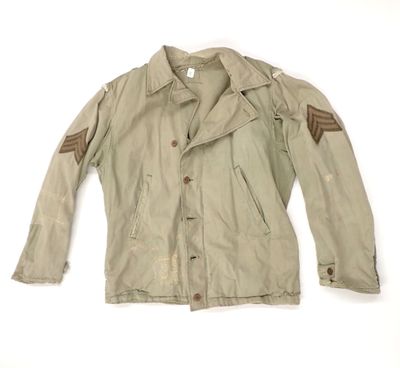 an old military jacket with patches on the sleeves and shoulder