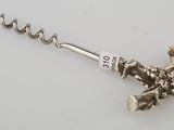 an image of a bottle opener with a corkscrew on a white surface