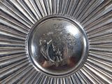 a silver plate with a picture of a lion on it