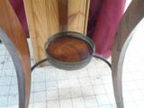 a wooden table with a metal bowl on top of it