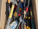 a cardboard box full of tools on the floor