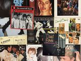 many different pictures of the same album covers on the wall