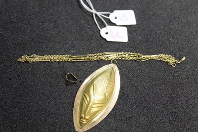 a gold necklace with a leaf on it and a silver chain