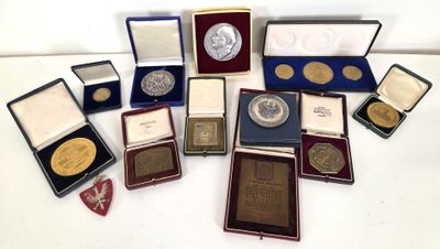 a lot of coins and medals on display on a table