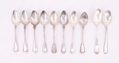 six silver spoons are lined up in a row on a white surface
