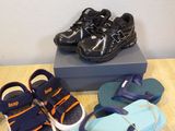 several pairs of children ' s shoes are on a table next to a box