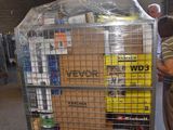 a man standing next to a cart with boxes on it
