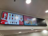 two large screens on the wall of a restaurant