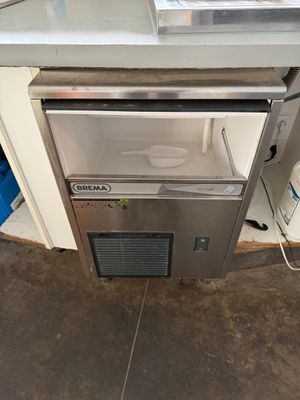 an image of a kitchen with a sink and a refrigerator