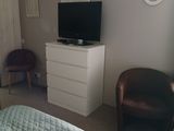 bedspread on a bed in a bedroom with a flat screen tv