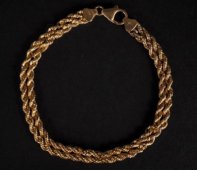 un bracelet en or en forme de corde avec un fermoir, sur fond noir