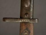 a close up of a metal object on a wooden pole