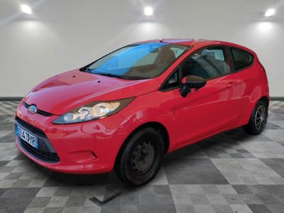 a red ford fiesta parked in a room with a checkered floor