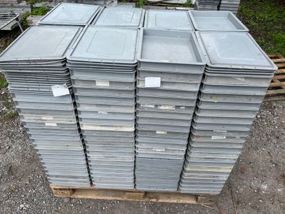 many stacks of metal containers stacked on a pallet