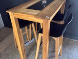 a table with two chairs and a glass on top of it