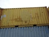 a yellow and blue container sitting on top of a building