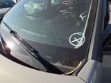 a car that has a sticker on the windshield of it