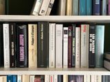 many books that are on a book shelf together