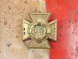 an image of a cross on a red and white wall