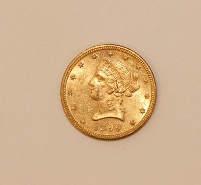 an image of a gold coin with a woman ' s head on it