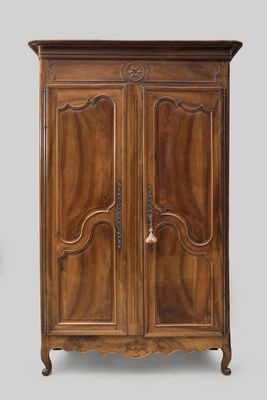an old wooden cabinet with two doors and a drawer on top of it