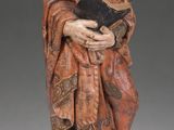 a statue of a woman holding a book in her hands