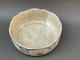 a white bowl with blue designs on it on a table